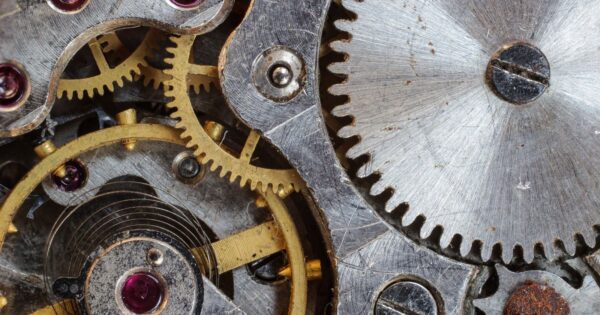 Detailed close-up of interlocking gears and cogs in a complex mechanical system.