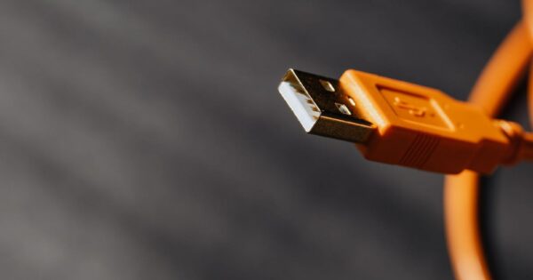 Detailed shot capturing an orange USB cable connector on a contrasting background.