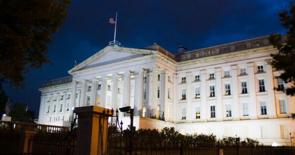 Stunning view of the U.S. Treasury Building illuminated against a twilight sky in Washington, DC.