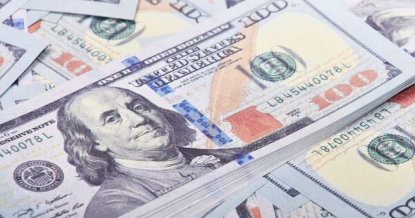 Detailed close-up of United States 100 dollar bills emphasizing currency and finance.