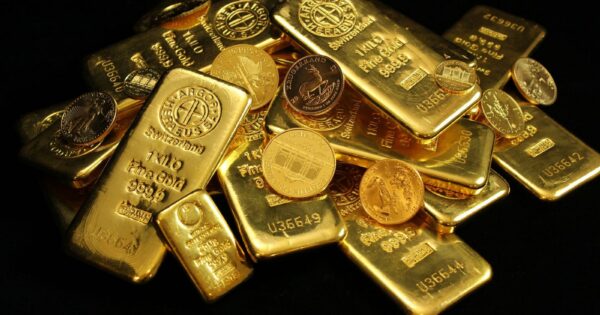 A collection of shining gold bars and coins symbolizing wealth and investment.