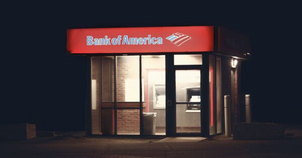 Illuminated Bank of America ATM structure against a dark nighttime backdrop in Boston.