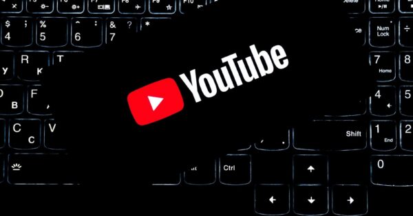 YouTube logo displayed on a backlit keyboard, representing digital media and online content creation.