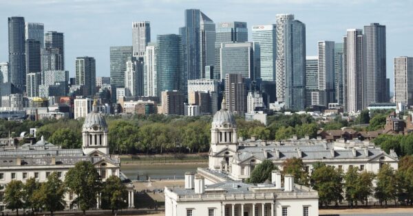 Panoramic view of Old Royal Naval College and modern skyscrapers in London.