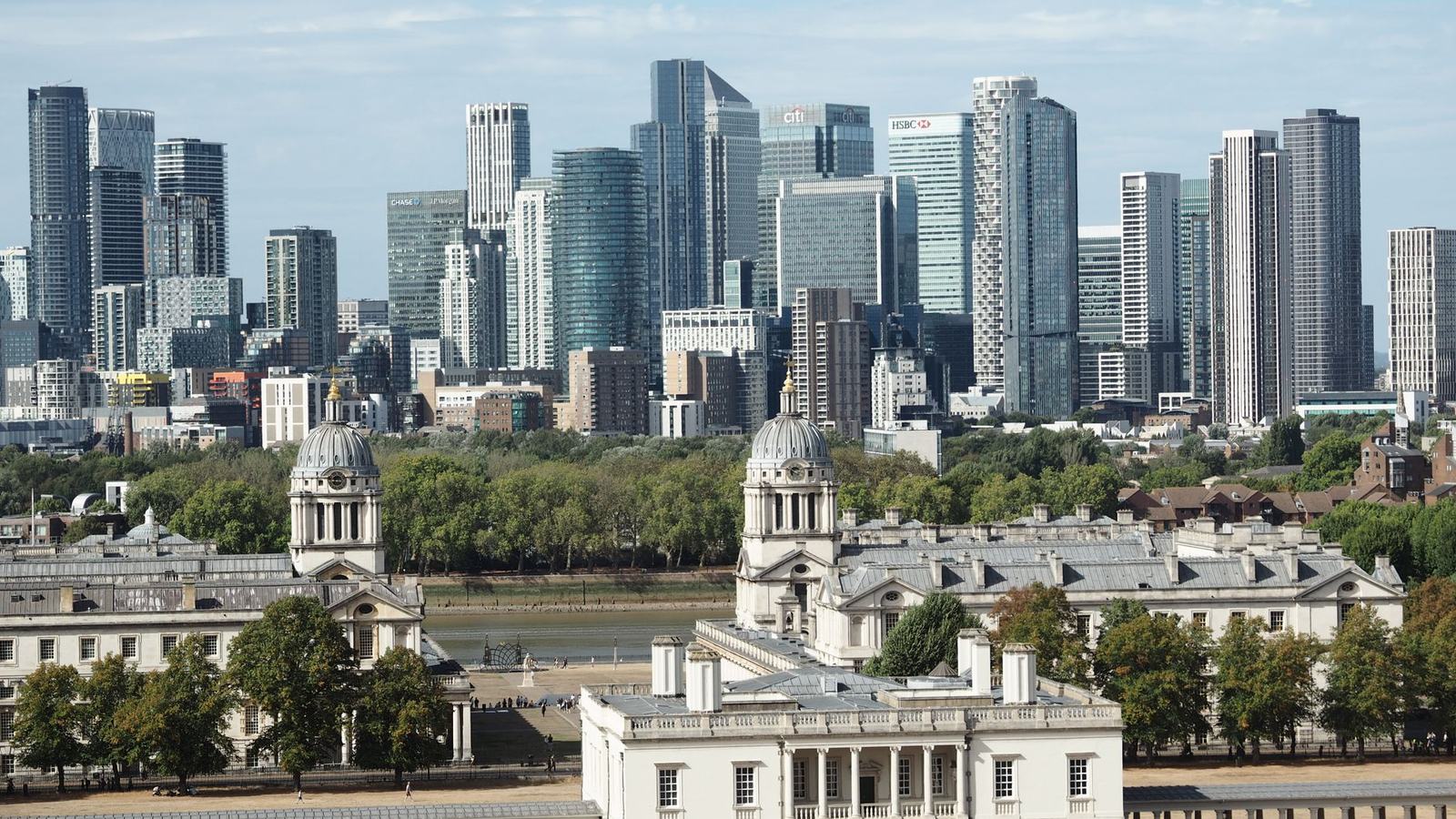 Panoramic view of Old Royal Naval College and modern skyscrapers in London.