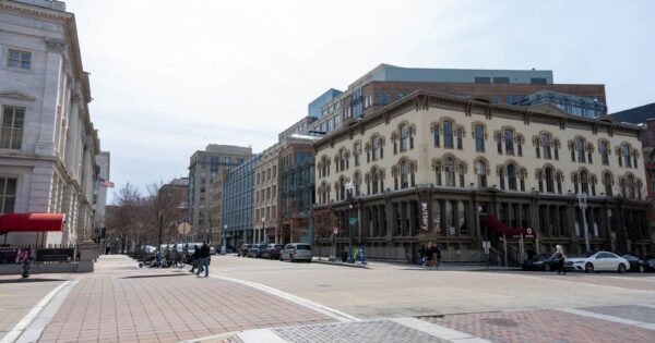 View of historic architecture and streetscape in Washington, D.C. on a sunny day.