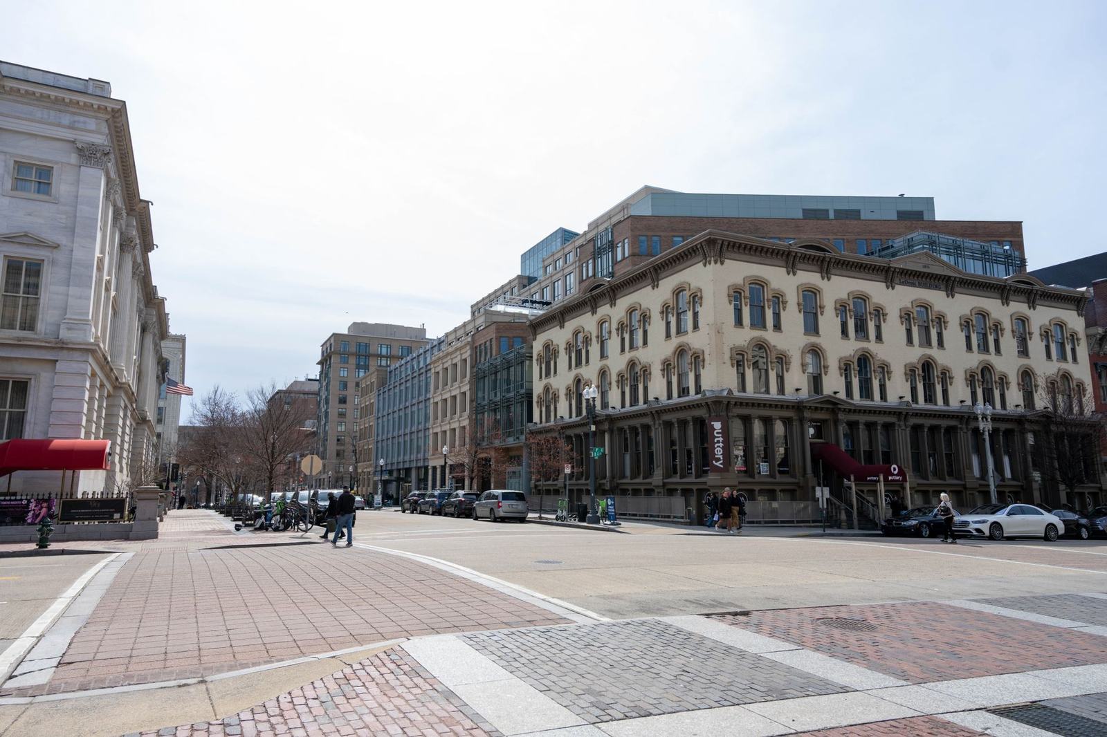 View of historic architecture and streetscape in Washington, D.C. on a sunny day.