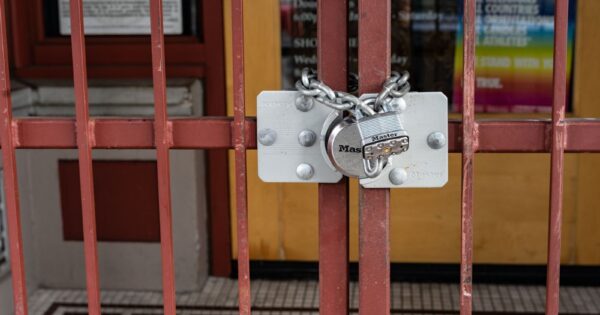 Iron gate with a padlock securing a closed entrance in Portland, Oregon.