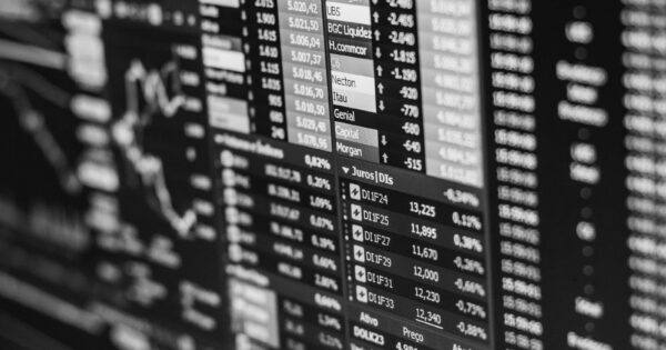 Monochrome image of stock market data on a screen, depicting financial information and trends.