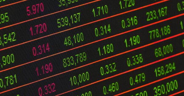 Close-up of a digital stock market data display showing colorful financial numbers and trends.