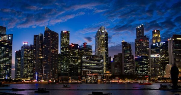 Spectacular view of Singapore's skyline with illuminated skyscrapers against a twilight sky.