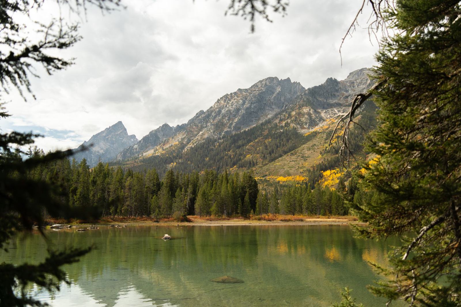 Serene autumn landscape of Grand Teton National Park with lake and mountains.