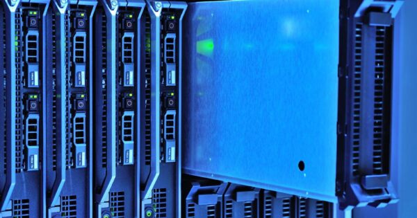 Detailed view of server racks with glowing lights in a data center environment.