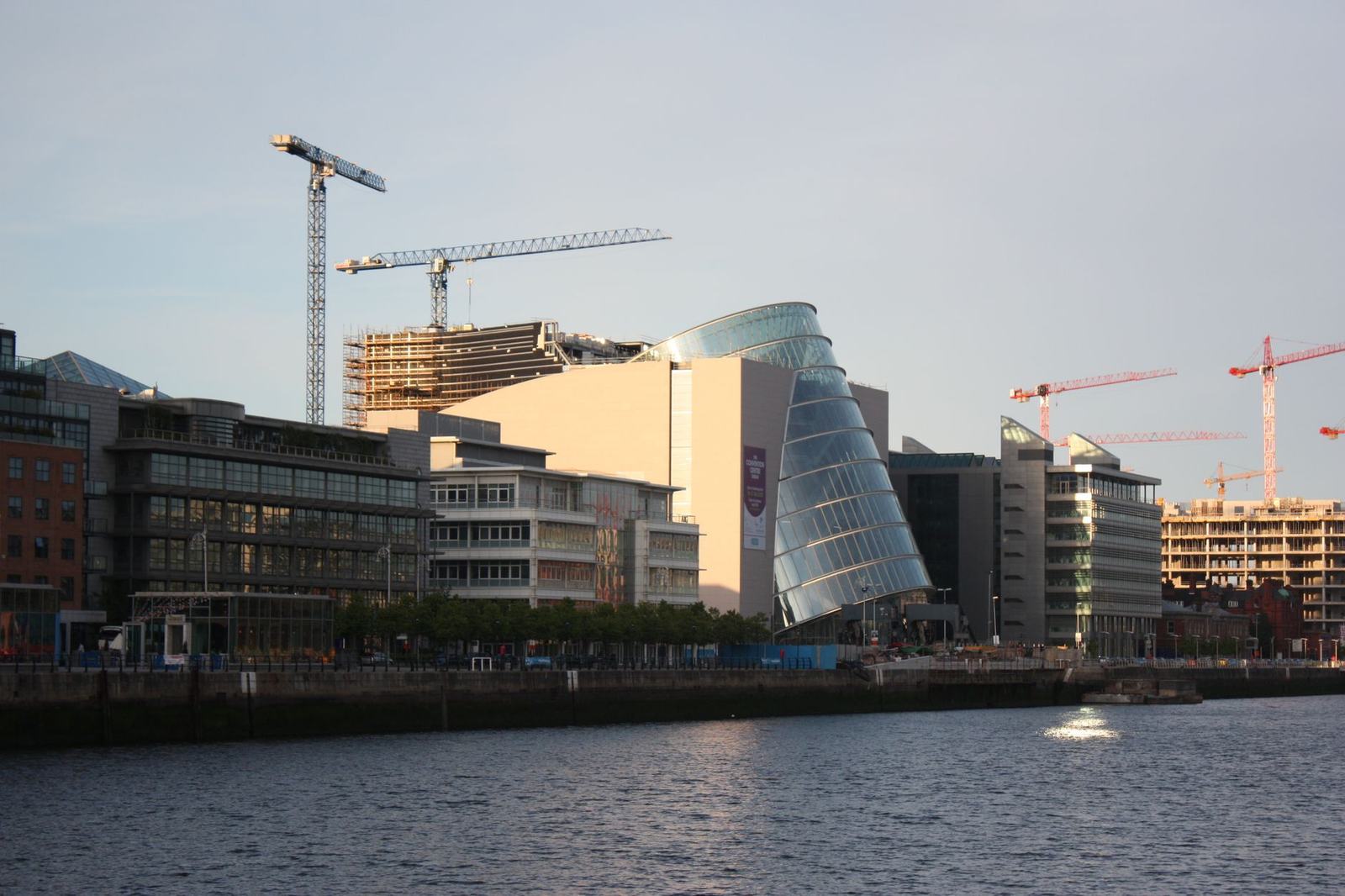 Contemporary architecture and construction cranes along Dublin's iconic waterfront.