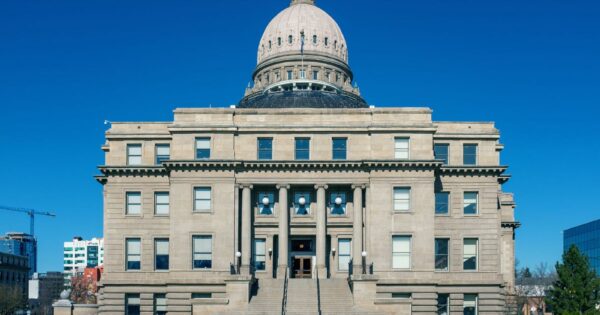 Front view of the historic Idaho State Capitol Building under blue skies in Boise.