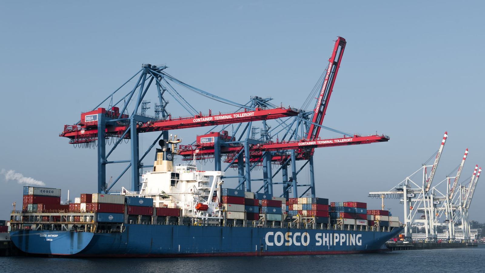 COSCO shipping vessel docked at Hamburg port terminal for global freight transport.