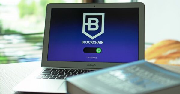 Laptop with blockchain application interface connecting. Ideal for tech and crypto themes.